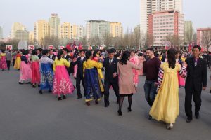 Foreigners partake in a mass dance in Pyongyang, on a North Korea tour