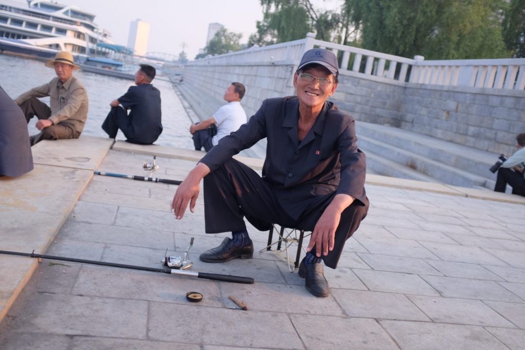North Korean man fishing in the Taedong river, Pyongyang, North Korea.