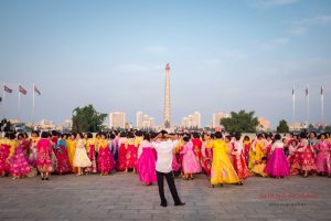Post mass dance in Kim Il Sung Square. The Juche Tower can be seen in Pyongyang, North Korea