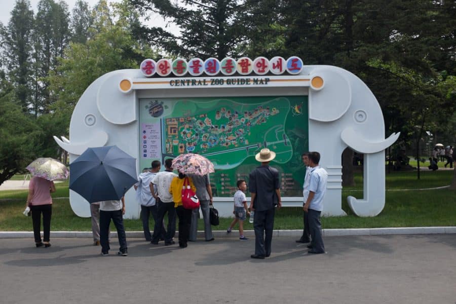 Locals looking at a map of Pyongyang Zoo