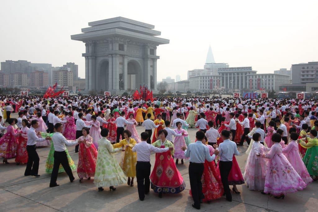 North Koreans dance next to the arch of triumph on April 15th, birthday of Kim Il Sung.