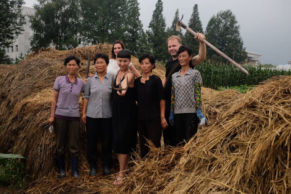 our group hanging out with North korean farmers on a DPRK tour