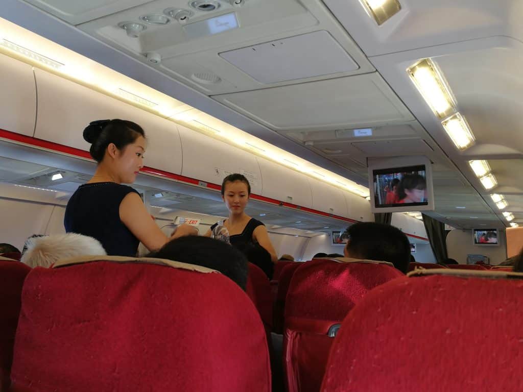 Air Koryo cabin crew serving drinks